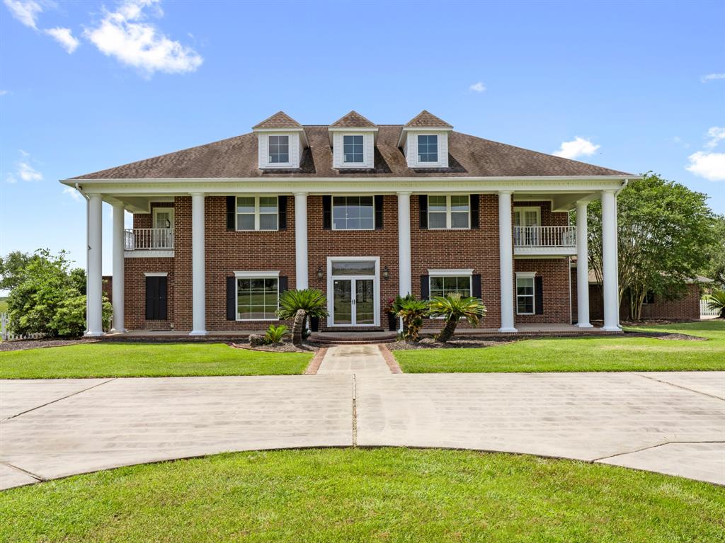 2976 County Road 218 Bay City, Texas Meticulously maintained custom masterpiece that's inviting & impressive! The design offers seamless flow from the formal living & dining rooms to the gourmet kitchen. The soaring 2 story ceilings in the living room are magnificent! The primary suite is a true retreat, featuring a private loft & spa-like en-suite bath. Downstairs is complete with a private office. Upstairs, you'll find a bonus room alongside 4 spacious bedrooms, including a private guest suite. The outdoors will be a tranquil escape with the sparkling pool surrounded by Cool Deck. But the real showstopper is a 5,000sqft. horse barn, complete with concrete floors, 3 Priefert horse stalls, large tack room, & an indoor riding arena! Plus, there's another insulated metal barn which offers 220V hookups for welding. Multiple balconies, white picket fences, & a concrete circle driveway add to this home's grand curb appeal. Don't miss this rare opportunity to own a local icon that perfectly blends luxury and functionality!