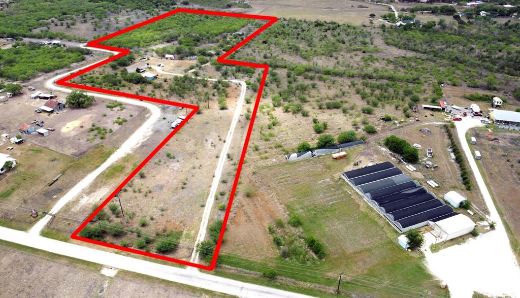 488 Union Wine Road New Braunfels, Texas Escape to the tranquility of country living on this expansive 13+ acre farm and ranch property in New Braunfels. This idyllic property offers exterior amenities including a farm storage building, chicken coop, and stock ponds/tanks. The main residence, a comfortable four-bedroom home, welcomes you with an open floor plan featuring a built-in entertainment center, an island kitchen with a unique wood chop block countertop and tile backsplash, and striking beamed ceilings. Enjoy peaceful moments on the spacious front covered porch, offering picturesque views of your land. The primary bedroom suite provides a relaxing haven with a walk-in closet and a private bathroom featuring dual sinks and a tiled walk-in shower. Each of the three additional bedrooms includes a convenient built-in desk. For guests, a charmingly rustic one-bedroom guest house with attached carport awaits, complete with a metal ceiling, warm wooden walls, and a bathroom with a stand-up shower.