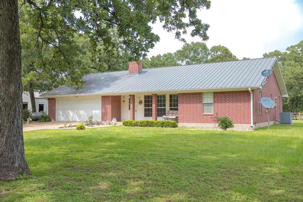 4988 Paso Fino Lane Madisonville, Texas Exceptional Ranch Style 3-bed/ 2-bath home that spans over 29.66 scenic acres in Madisonville, TX. Home features 2 kitchens, spacious family living areas that includes a custom brick design fireplace for your pleasure, bedrooms that are cozy and well appointed. Many custom details are found throughout home: central vac system, firewood room, closets, cabinets, niches. Established utilities for your convenience: water wells, propane, generator-propane generated-18kw, satellite. The back covered patio area has a relaxing, tranquil setting with mature timber and abundant wildlife. Additional structures that complement the stately property include a horse barn, 24x36 shop, cottage-style casita with electricity/ plumbing. Currently, maintained Agriculture Exemption in place. Call today to schedule your tour of this peaceful retreat, home awaits you and your family!!