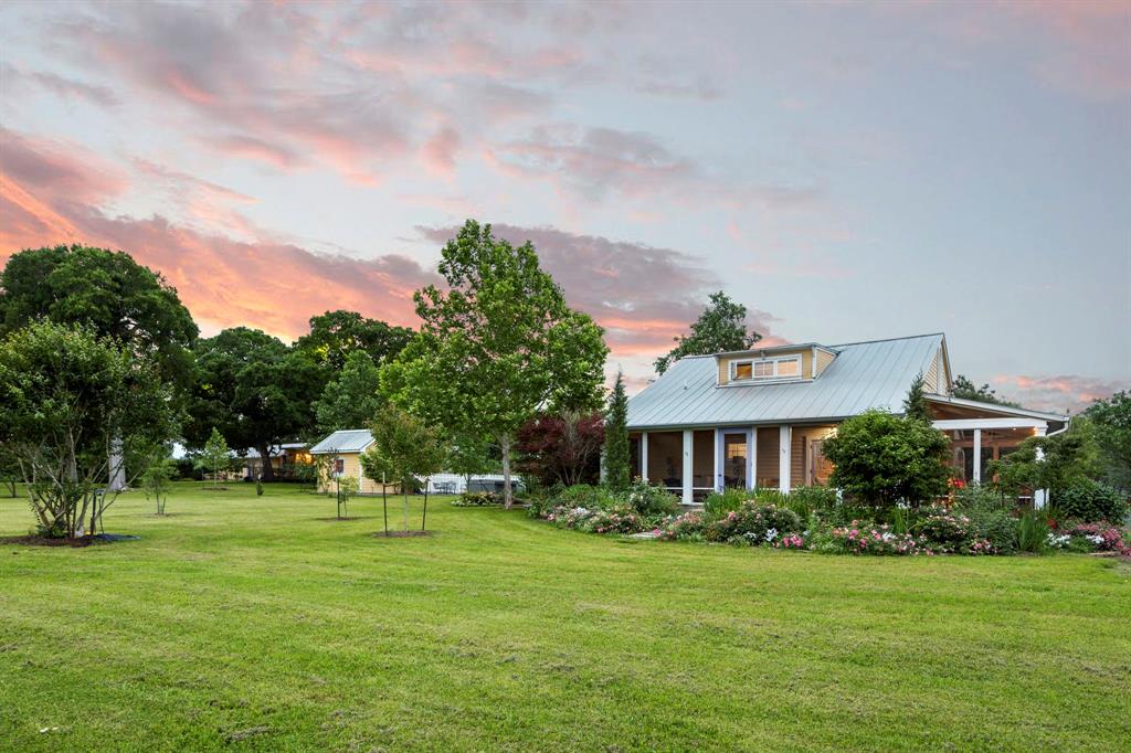 3100 Trails End Lane Brenham, Texas Situated at the gateway of Texas Hill Country, this incomparable property consists of 20 of the most breathtaking acres you will ever come across. With thousands of trees & rose bushes, that include Live Oaks, Post Oaks, Peggy Martins & more, the owner has provided 24 meticulous years of care for the landscaping. Adjacent to the 45' x 14' swimming pool, is the main, 2,400+ sq.ft. 3-bedroom residence. A 1,600+ sq.ft. guest cottage that can sleep 4 is close by but maintains enough distance for privacy between the 2 residences. A few steps away is a 2,500+ sq.ft. 'barndominium' where you find a downstairs double-queen bedroom, bathroom & kitchen along with an upstairs bathroom & spacious bunkroom/playroom bringing the total sleeping capacity to 16. The property has 49 solar panels, county water for the residences & a well for irrigation as well as beautiful herbaceous gardens. Conveniently located 7 miles south of Lake Somerville, 3100 Trails End is about 20 minutes away from Round Top.
