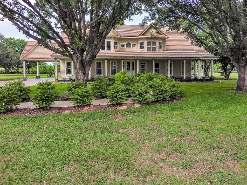 Rare opportunity in one of Fulshear’s most sought-after locations! This beautiful 7.03-acre gentleman’s ranch is surrounded by mature trees and is perfect for horse lovers. The property is fully fenced and cross-fenced, featuring a 30x40 shed ideal for horse stalls & a wash station, plus a 30x48 workshop. Enjoy the screened-in chlorine pool for relaxing or entertaining.

About 6 acres have an agricultural exemption for bees, helping keep taxes low. The charming 2-story home showcases Texas-style living with a tile roof, large front & back porches, wood & tile floors, granite countertops, and a cozy wood-burning fireplace.

The spacious primary suite offers views of the pool and features a luxurious bath with separate his & hers vanities, air spa tub, and a unique petrified wood sink with leather-like granite. Upstairs you'll find large secondary bedrooms & a huge game room with beautiful wood paneling.

LOW TAXES– don’t miss this unique ranch lifestyle close to city conveniences!