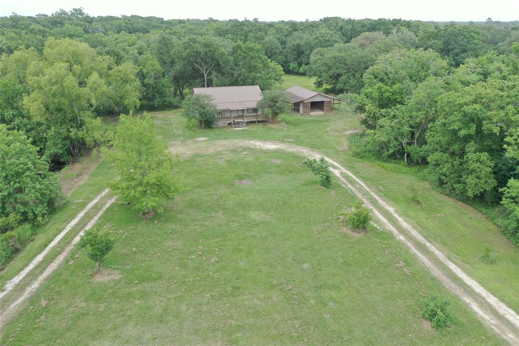 Over 15 Acres with with 2 entrances and Hwy 35 frontage.  2 bedroom 2 bath home with metal roof, tucked away centrally on the property with views of both ponds from the huge front porch.  2 amazing ponds = fishing and wood ducks.  Tons of wildlife including deer.  Detached barn/garage also has metal roof and houses the water well.