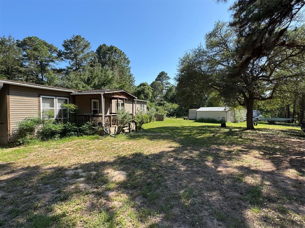 This 1792 SF 3/2 manufactured home offers privacy on a 9.68 acre tract of undeveloped, mostly wooded land. The home is surrounded by towering pines, mature live oaks and native cedar trees. The patio doors lead out to a covered back porch overlooking a fenced back yard surrounded by woods. Two storage buildings convey. The home and land will need some TLC, has plenty potential. Seller will convey any and all minerals owned. This property would make a nice weekend getaway, it is in a great location being just minutes away from Splashway Waterpark & Campgrounds in Sheridan and other local attractions. Do not trespass on the property, the property will be shown by appointment only with twenty four hour notice.