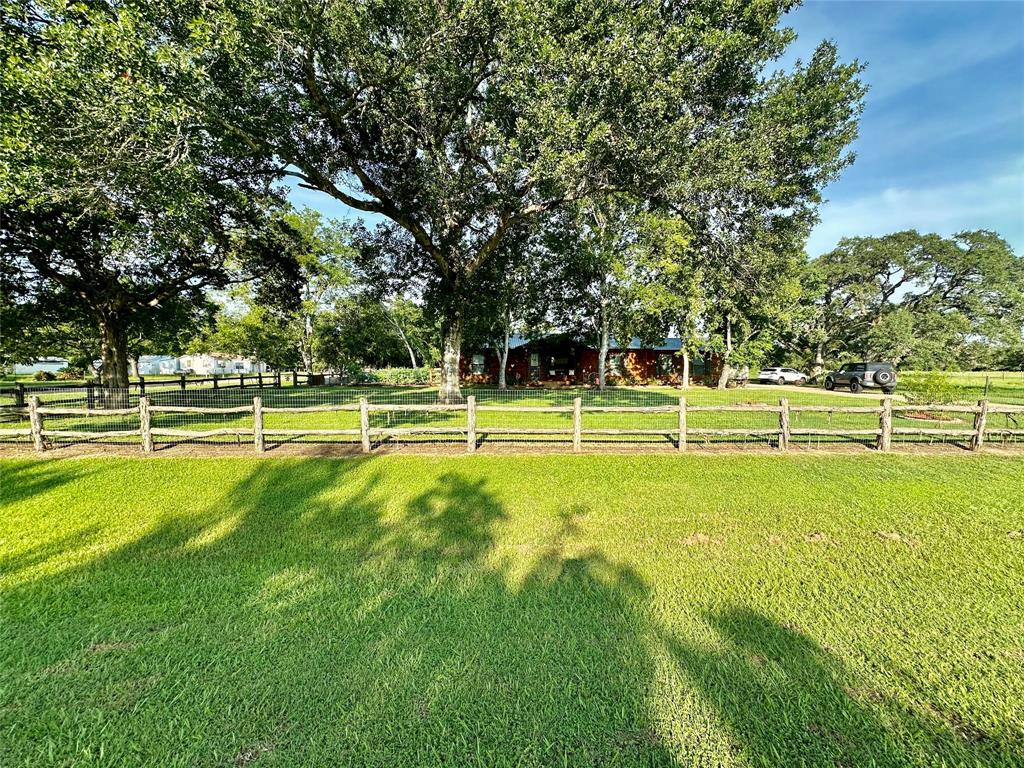 3571 County Road 106 Garwood, Texas Move in Ready! NEW FLOORING getting installed soon. Are you looking for a mini paradise in the countryside? This recently renovated home on 7.46 acres with a new 20x20 garage, two ponds and garden may be it. Fully fenced with an electric gate. The cross fencing for horses is a bonus for equestrian enthusiasts or those interested in keeping livestock. Beautifully landscaped around the home with front and back porches that are charming and inviting, ready for enjoying the views. The inside has rustic features that create a modern yet cozy home space that blends seamlessly with the charm of this country home. The addition of quartz and wood countertops to the kitchen along with stainless steel appliances and a tile backsplash make this large kitchen the heart of the home. The bedrooms are split layout. The primary bedroom that can fit oversized furniture and has a sitting area, barn doors and in-suite bathroom with huge shower. New central AC. **This is not a mobile or modular home.
