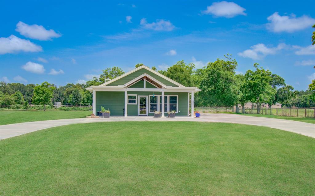 Welcome to this beautifully designed contemporary/modern home nestled on nearly 10 acres that is currently AG exempt! This spacious single-story home offers a rare blend of comfort, style, and privacy. Step inside to discover a bright and open floor plan featuring high ceilings, a spacious living room with a wood-burning fireplace, and a kitchen that’s perfect for entertaining. The kitchen boasts a large island with cooktop, breakfast bar, double ovens, and a Butlers Pantry with room for a coffee bar and freezer, seamlessly flowing into a generous breakfast area and formal dining space. The expansive primary suite includes a luxurious en-suite bathroom complete with double sinks, a soaking tub, separate shower, and walk-in closet. Each secondary bedroom is thoughtfully sized, and the home includes a dedicated utility room for added convenience. The property also includes a large fishing pond, a detached 40X40 workshop/Man Cave, Pecan orchard and fruit trees, plus Easy access to I-45!