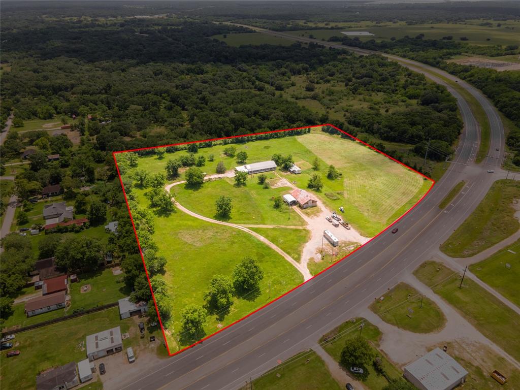 34678 Fm 1301 Road West Columbia, Texas Prime 8.9+/- acre property fronting Highway 35 and located on the edge of growing West Columbia, TX. Well-built 3/2, 2094 sqft home with long covered deck/patio, sits back from the highway, offering added privacy. 2/1 mobile home near the house, will need full rehab, but has been used in the past as a rental. Strong commercial potential - lay down yard, storage, store front, warehousing, retail, etc. Over 700' frontage along busy four lane Hwy 35, and only 1/2 mile from the new overpass at the Hwy 35 & Hwy 36 intersection. Graveled portion near Hwy frontage currently used as a "park and sell". Large barn, built with heavy timbers, near frontage. Majority out of floodplain, zone x. Priced to sell! Call today.