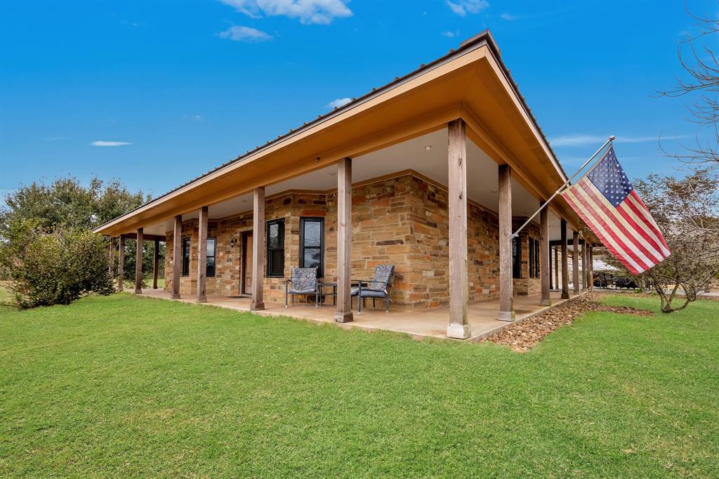 500 County Road 2276 Cleveland, Texas Nestled on +/-14.37 Acres, this Stone Ranch Style home offers an open-concept living room with a Stone faced gaslog fire place, high beamed ceiling, Andersen Windows and stained concrete floors. The Island granite kitchen features SS appliances and an Eat-At Breakfast bar, connected to a Formal dining space. The Master Bedroom boasts a tub, separate walk-in shower, and walk-in closet. Enjoy the fenced property with a 60X60 concrete shop, separated & fenced dog runs with doggy doors to enter the shop for bedding or comfort, hot water heater, shower, toilet, and three sink trough. Relax on the wrap-around porches, by the saltwater pool, or in the hot tub. Don't miss out on this opportunity!