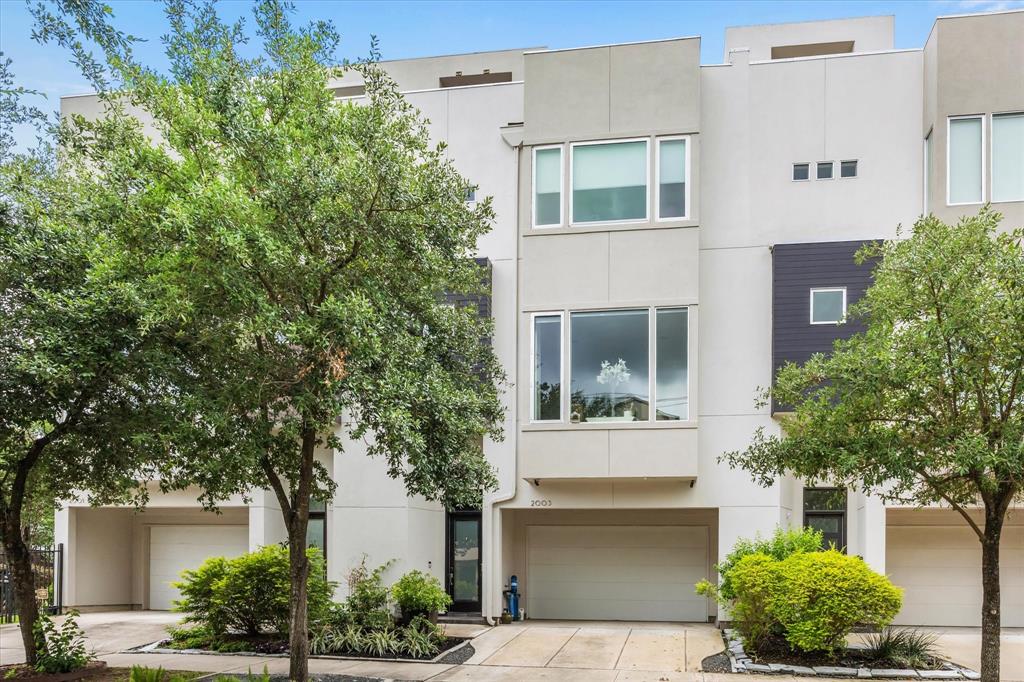 2003 Vermont Street Houston, Texas Urbane, urban living is found in this handsome, soft contemporary, elevator capable patio home steps from River Oaks Shopping Center. Updates + upgrades surround you inside this very slick home. Down the Entry, past the Drop Zone is a Suite with updated Bath + walk in Closet. Open concept Second Floor has daylight streaming from all directions. Spacious chef's Kitchen is updated with quartz counters, featuring Gas Cooktop + copious amounts of Cabinets--including beneath the quartz topped Breakfast Bar! Beside the Kitchen is large Dining Room; straight ahead is commanding Great Room with treetop view. Master Suite has hardwood floors, huge walk-in Closet and avant garde Bath with quartz counters, more closets, a stall shower + bubble tub. Third Suite + Utility complete the floor. The crowning jewel is the Rooftop Terrace w/Summer Kitchen + skyline views. Other luxuries: Savant system, PEX piping + more! If you're cool with cool: This home is very cool.
