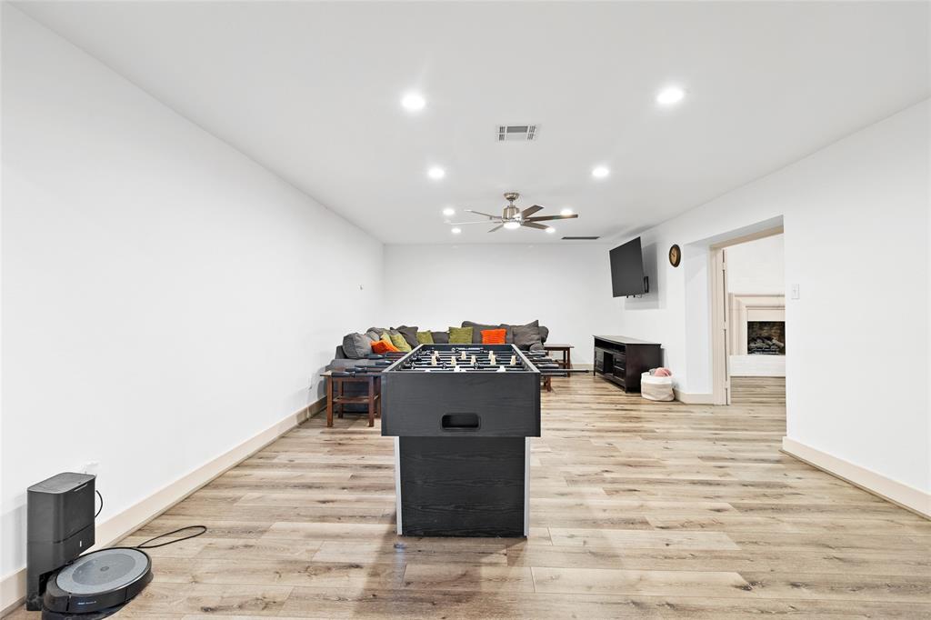 Your formal living room offers a spacious and flexible layout, ideal for use as a media room, game room, or family lounge. Recessed lighting and neutral walls create a bright, inviting atmosphere, while wide plank flooring adds warmth and character. A ceiling fan ensures comfort, and the open doorway leads directly to your spacious flex space, enhancing the flow for both entertaining and daily living.