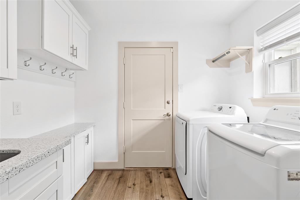 Enter your oversized bright and functional laundry space, featuring your washer and dryer space, built-in cabinets, hanging rack, and granite counter space—ideal for folding, sorting, or storing cleaning essentials. Convenient access to your backyard or garage adds an extra layer of practicality.