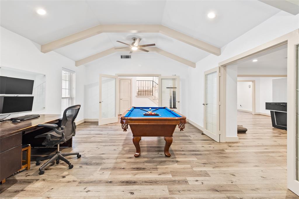 Located on the first floor, your spacious flex space boasts vaulted ceilings with exposed beams that add distinctive architectural charm. Wide plank flooring brings warmth underfoot, while generous windows fill the room with natural light, creating an open and inviting ambiance. Glass-paneled French doors provide effortless flow to nearby areas, making this the perfect space to enjoy as a media lounge, playroom, or personalized retreat.