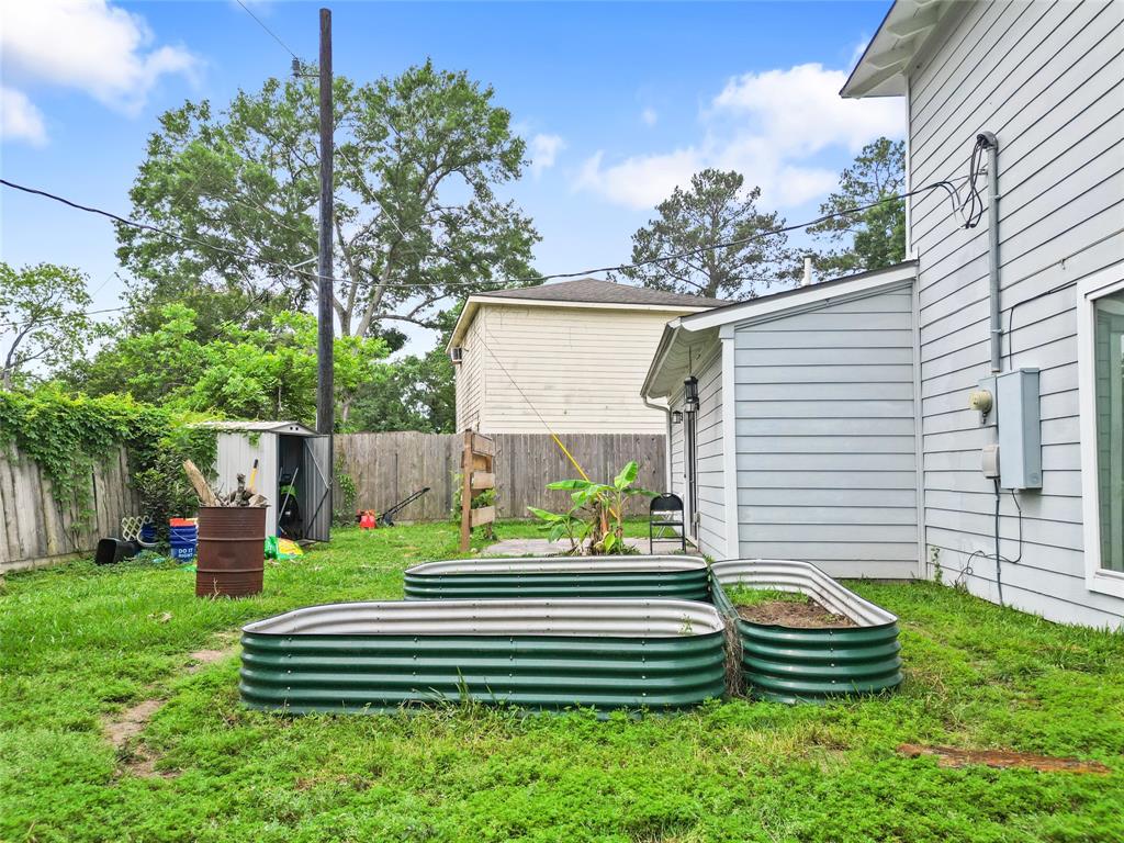 Your fully fenced backyard offers the perfect blend of privacy and potential, ideal for gardening or outdoor living. Raised garden beds are ready for planting, while the spacious grassy area offers room for play or expansion. Mature trees create a peaceful backdrop, and a tucked-away storage shed adds practicality. It's a versatile outdoor space ready for your personal touch.