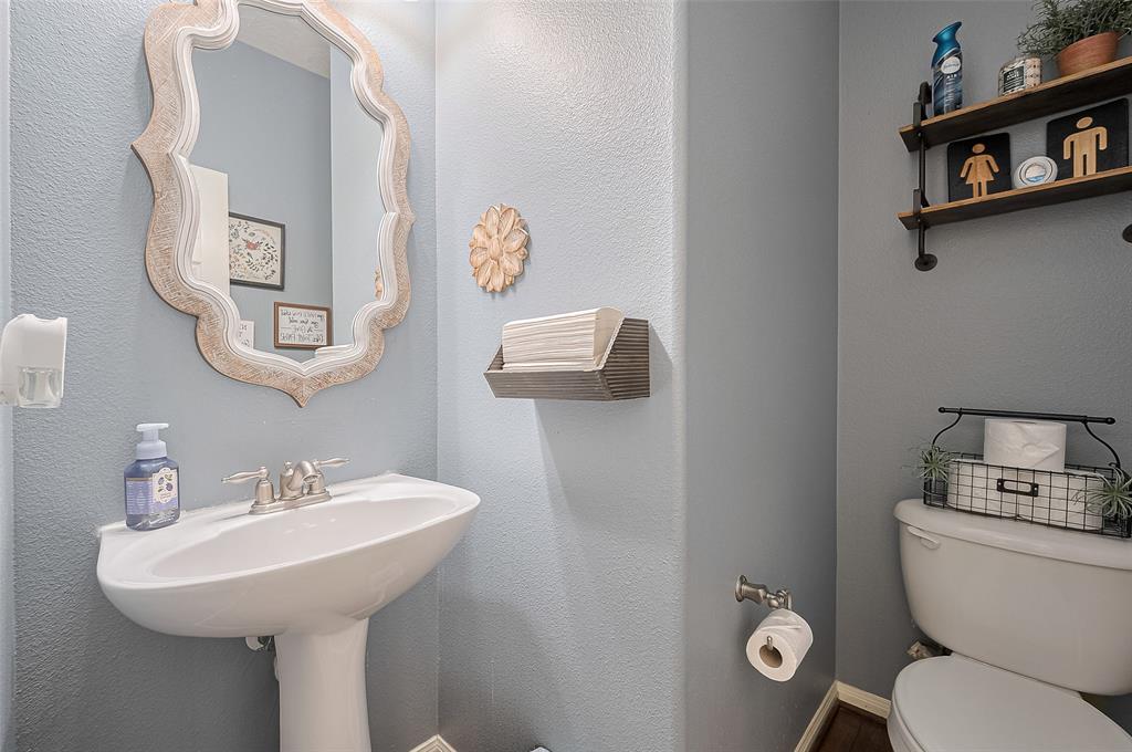 This conveniently located guest bathroom features a sleek vanity, bright lighting, and modern finishes. Perfect for visitors, it offers both style and function in a well-maintained space that complements the home’s overall design.