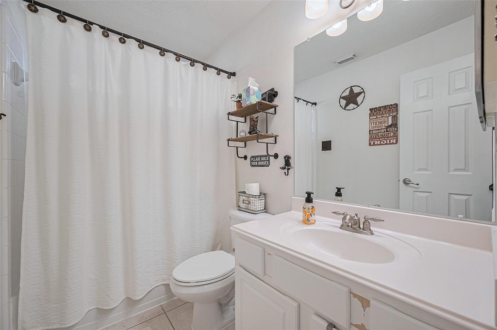 This full bathroom features a classic combination of a shower and bathtub, perfect for everyday convenience or relaxing soaks. Neutral finishes and clean lines make it a practical and welcoming space for both residents and guests.