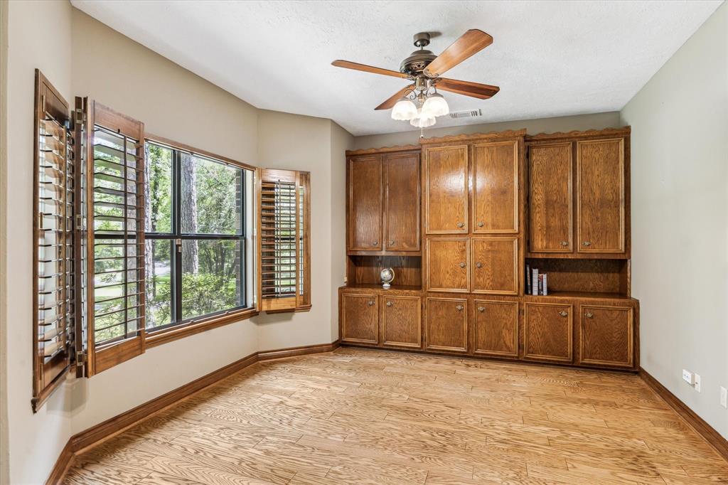 Office in the front of the home featuring the real wood floors, real wood cabinets, Beautiful Low E insulated windows and custom shutters.12190 Willowridge Cir