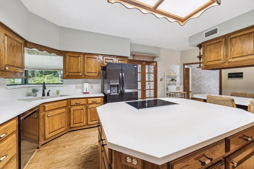 This kitchen is prettier in Person with its Brand-New Quartz countertops throughout, new refrigerator to go with the newer dishwasher. Double Oven, Big Sink, Undermount lighting, Instant Hot water from a water heater under the sink, New stove in the island and the Best Breakfast Bar around! Amazing window over the sink and a deep pantry, this kitchen has it all! Real wood, custom cabinets and a door leading outside as well for breakfast on the terrace. 12190 Willowridge Cir