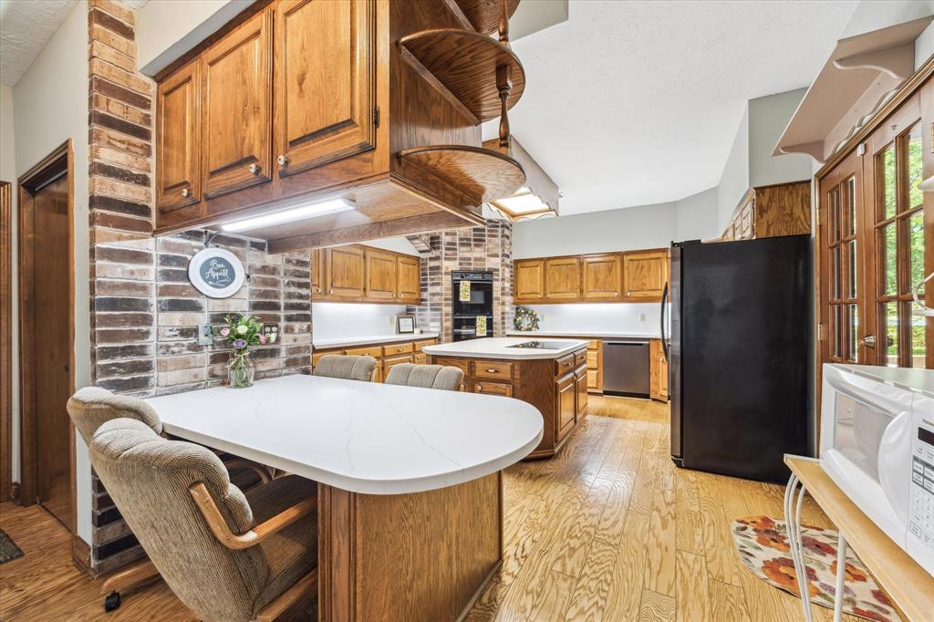 This pic is showing off the breakfast bar, there is a great broom closet around the corner in that open door and a few feet behind is another HUGE closet under the stairs. This home lacks nothing!12190 Willowridge Cir