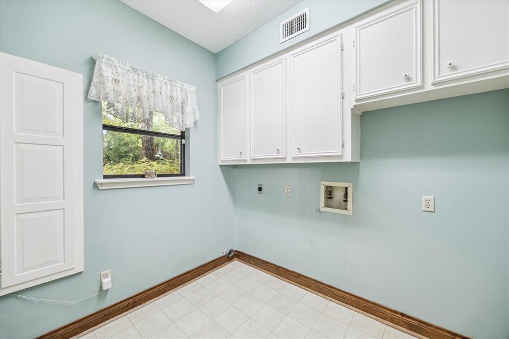 Laundry room is downstairs with a built in ironing board.12190 Willowridge Cir