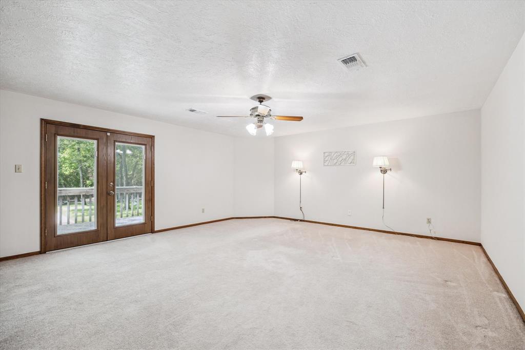 Mostly empty room waiting for your furniture. In this same room but no picture of it is a built in cabinet complete with a sewing board for your machine. Another fun fact the 2nd subfloor is made with 2x6 tongue and groove. Sturdy home! 12190 Willowridge Cir
