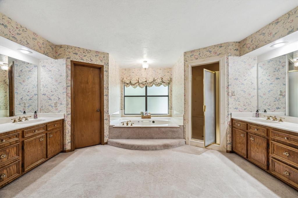 Primary Suite with a BIG soaking tub, Great size shower, His and Her and closets, Built ins in one of them, Vanity section, storage galore and Copper fixtures!12190 Willowridge Cir