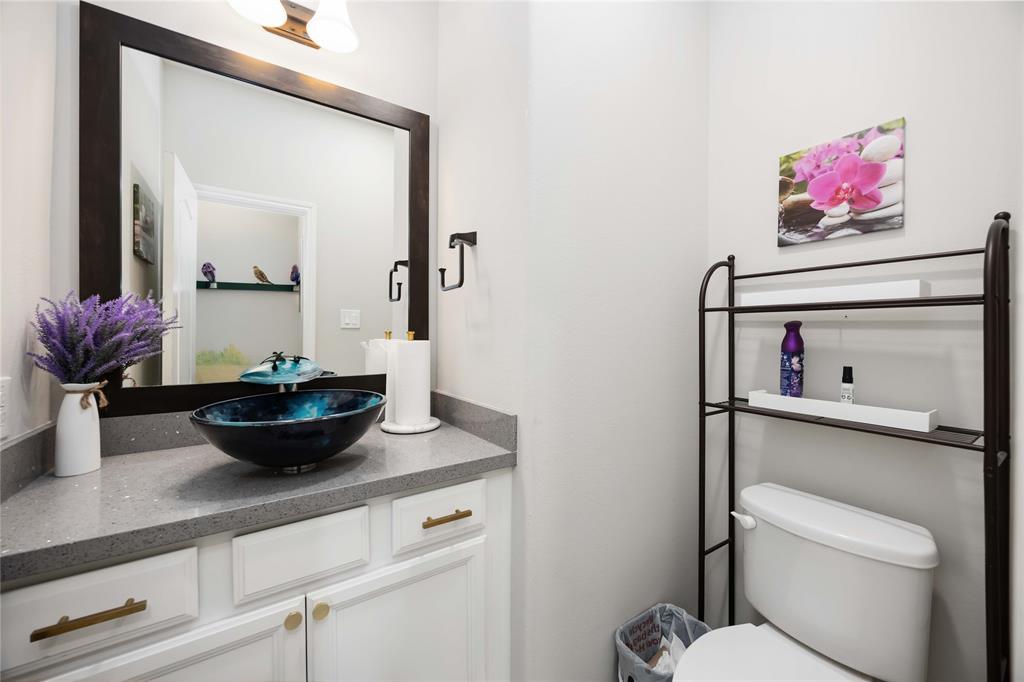 Upgraded half bath with blue waterfall vessel sink