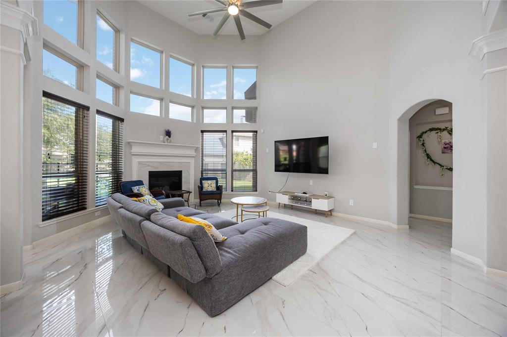 Family room with gorgeous floor to ceiling bow windows add ample natural light