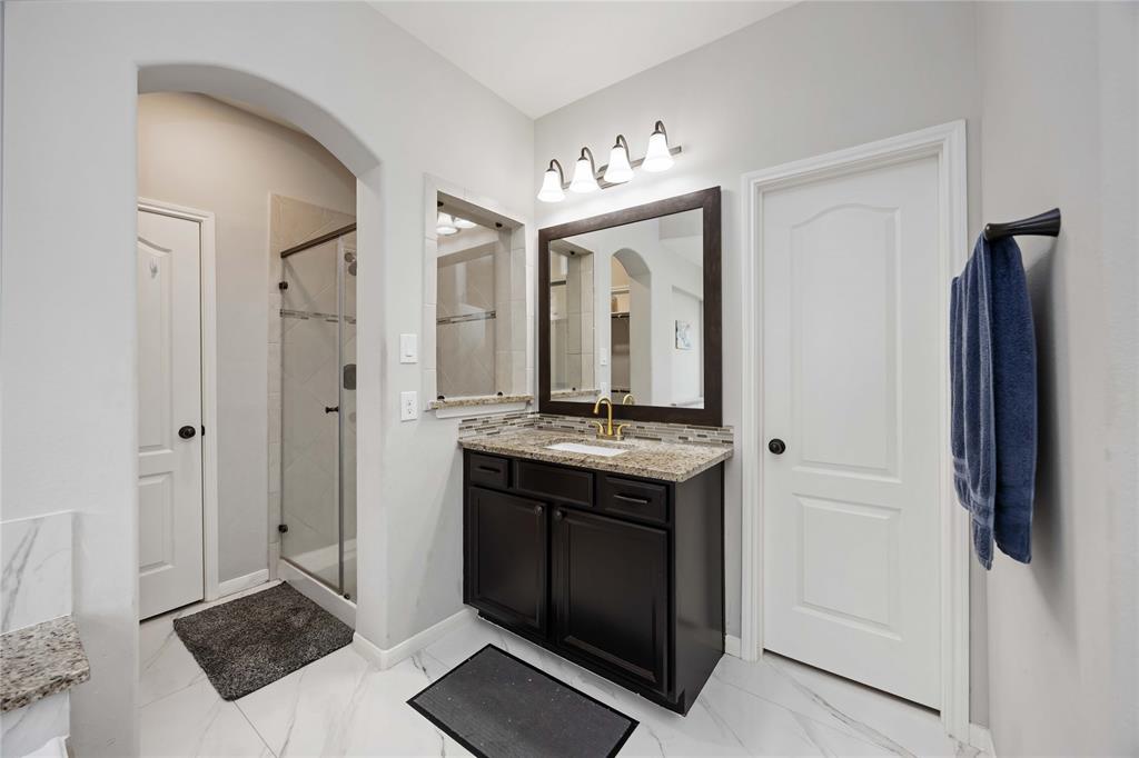The other primary bathroom vanity with the separate shower.There are two walk-in closets.