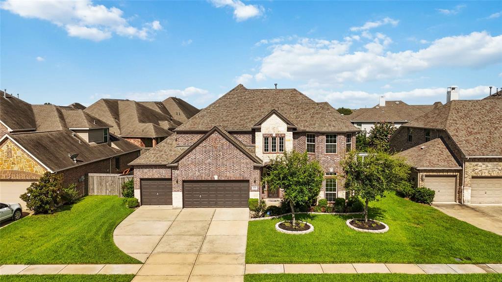 3 car garage each driveway with a large front lawn