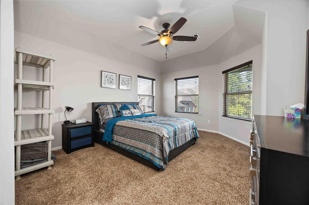 Spacious bedroom upstairs with backyard view