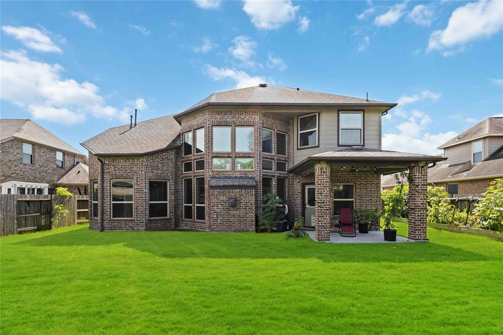 Back view of the home. 4-sided brick.