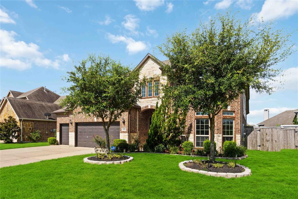 Curb appeal with rich landscape.