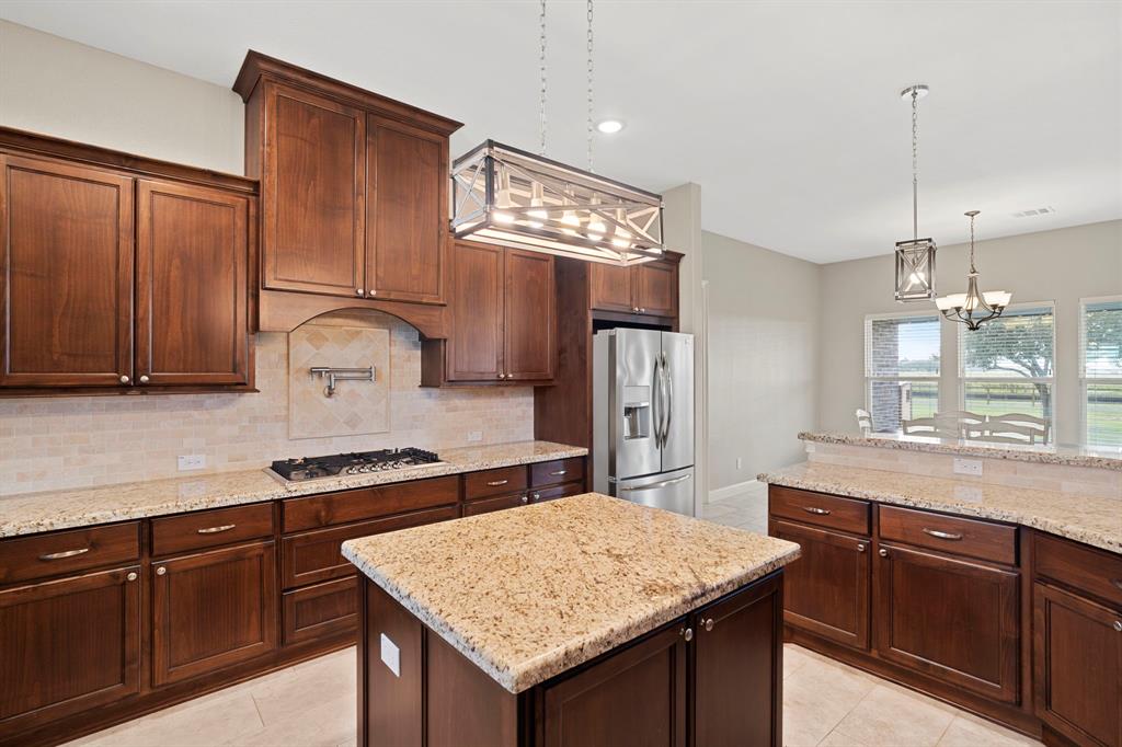 This magazine worthy island kitchen is a chefs dream. Double ovens, 5 burner commercial grade cooktop with griddle abundant cabinets and drawers to store all culinary tools. You will love this kitchen!