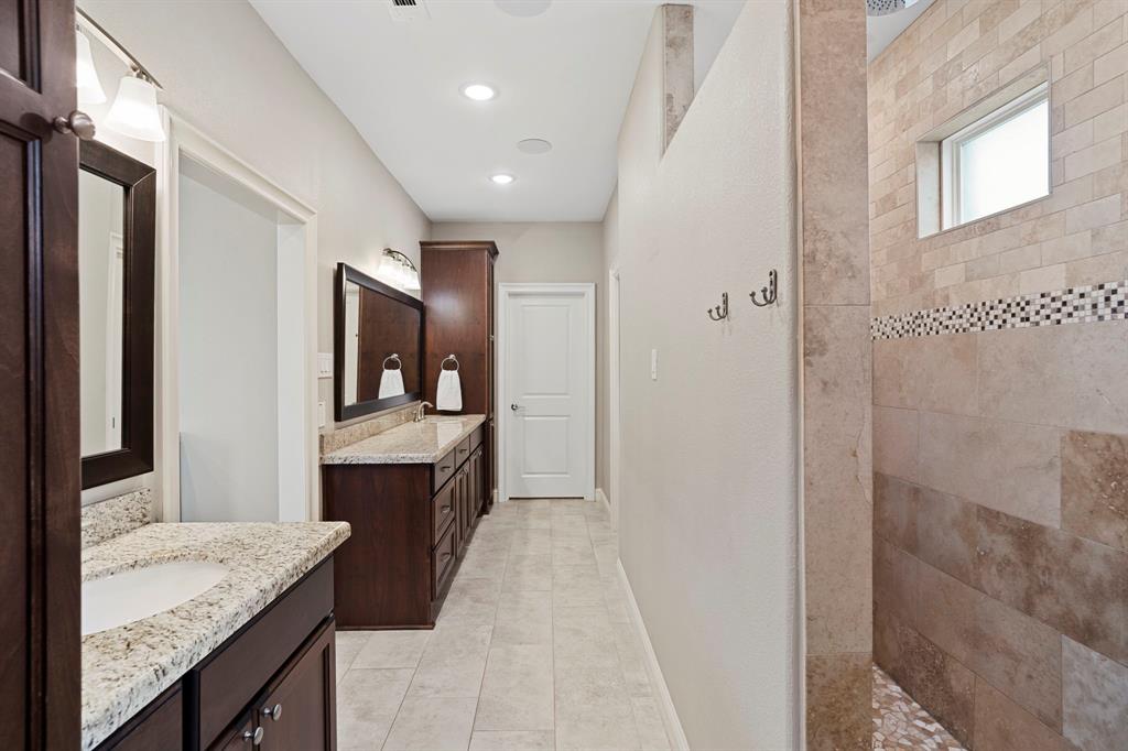 Luxurious spa like primary bath is absolutely stunning. Separate dressing areas and two massive walk in  closets.