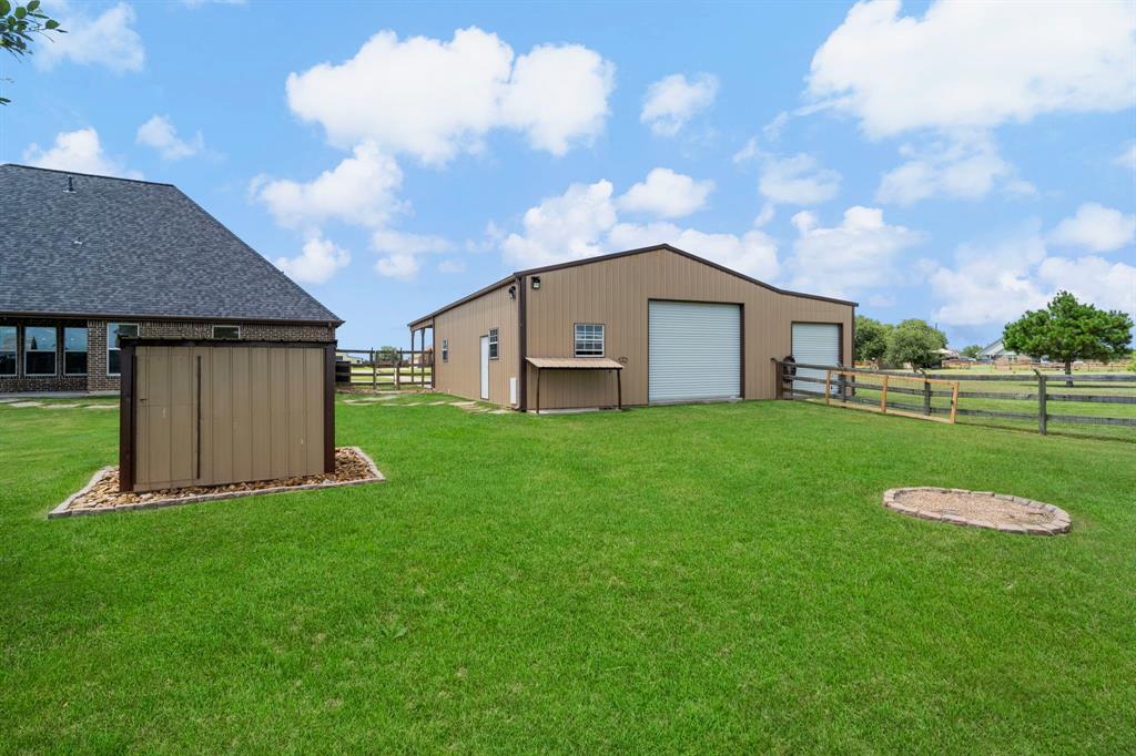 View of the back of the barn. Note the property line extends beyond the fence. The fenced area allows kids and pets to run and play.