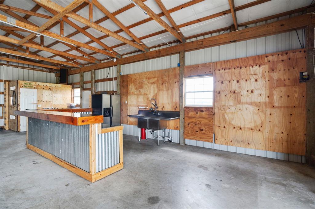The barn kitchen features a wrap around bar which seats 12. Abundant counterspace to host gatherings. The covered parking area is perfect for extended outdoor seating.