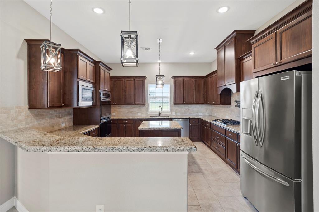 This kitchen is the heart of the home and this stunning one is sure to please! Abundant granite counter space to host the largest of gatherings. The large breakfast bar allows you to stay in touch with guests while entertaining.