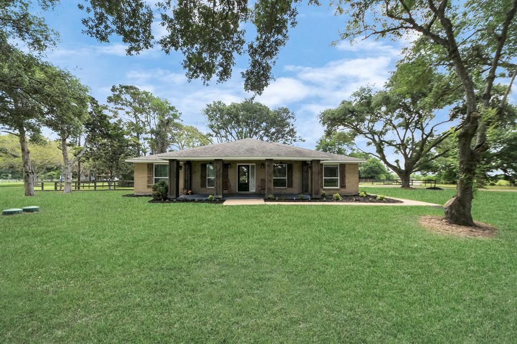 Charming ranch-style home on 5.5 scenic acres, nestled among centuries-old oaks. Wide front porch, peaceful setting, and elevated for added peace of mind—country living at its best.