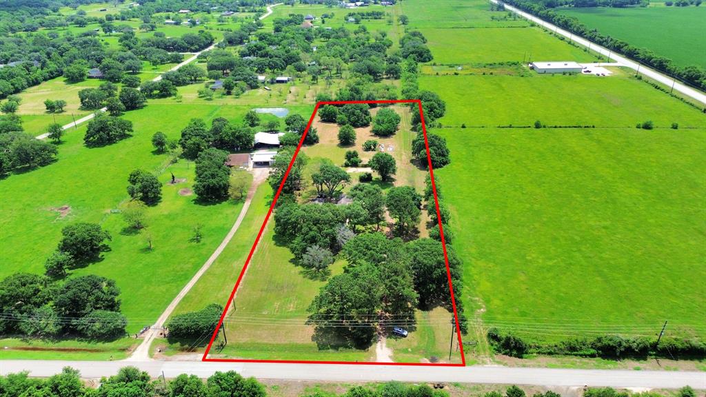 Spanning 5.5 acres, this tree-filled property sits at the front of the neighborhood on one of its highest points—offering space, privacy, and stunning natural beauty.