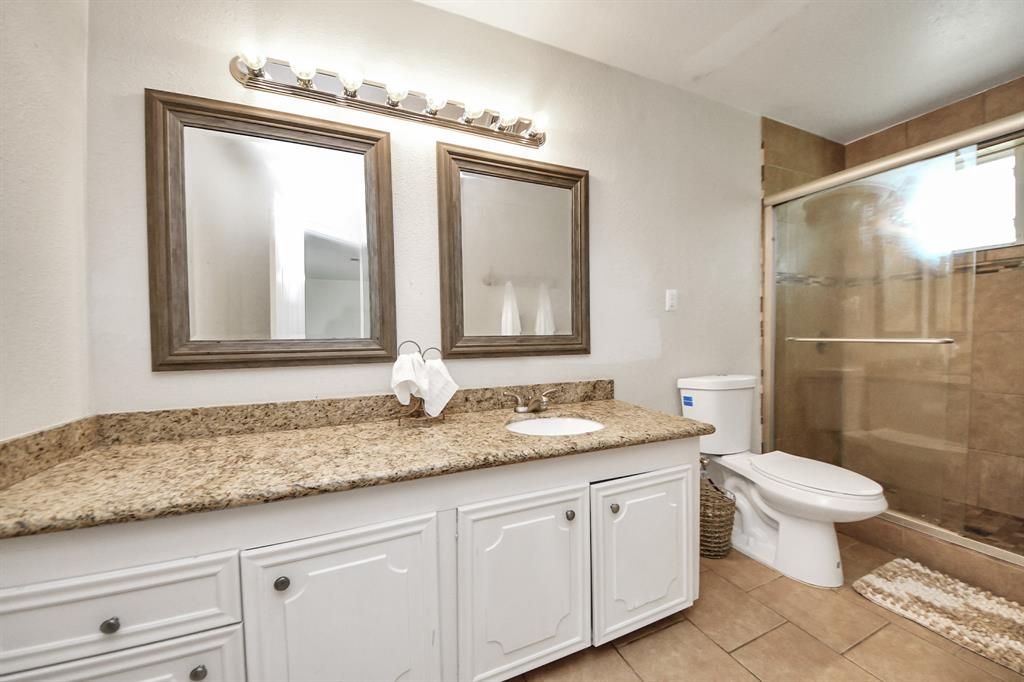 Features a large walk-in shower and generous countertop space—comfort and convenience in a stylish setting.