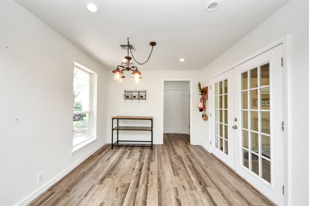 Sunny breakfast space with double doors leading to the side porch—blending indoor comfort with easy outdoor access.