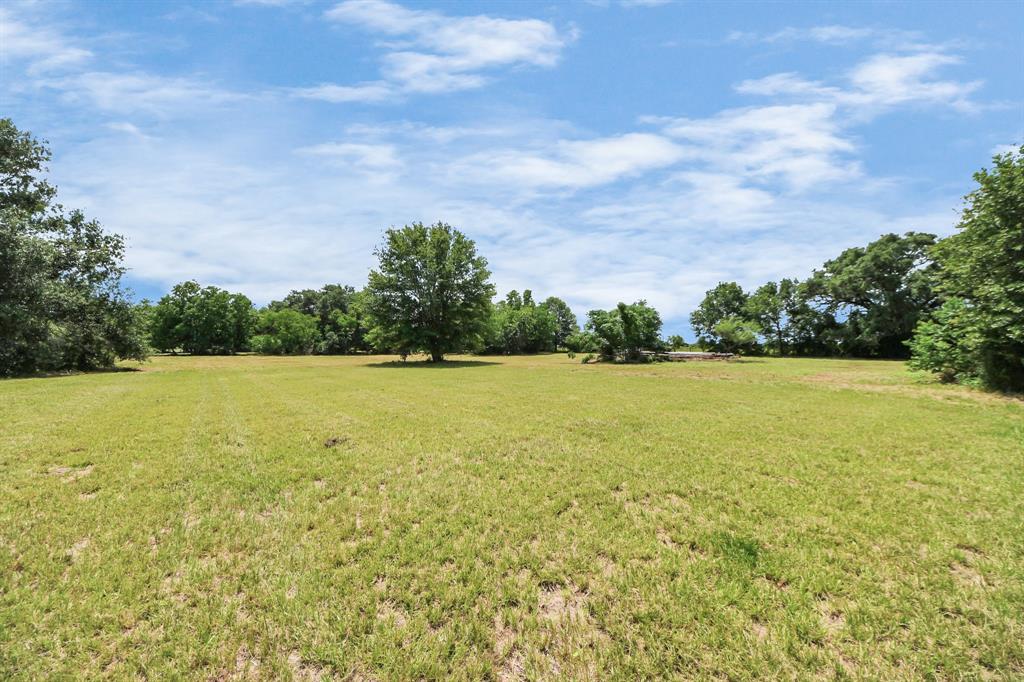 Additional open acreage beyond the fenced yard—perfect for horses, trails, or your dream barn.