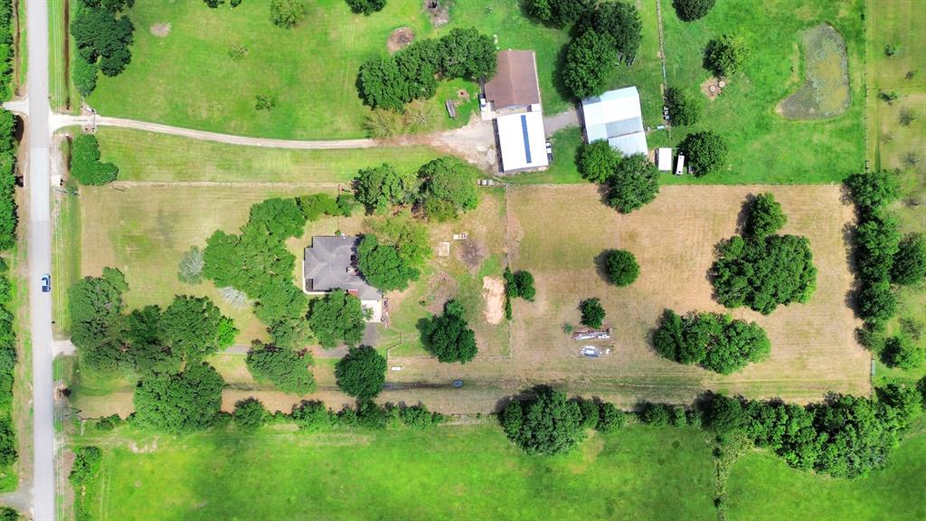 A stunning aerial view of your 5.5-acre haven—nestled among towering oaks with space to dream, grow, and thrive.