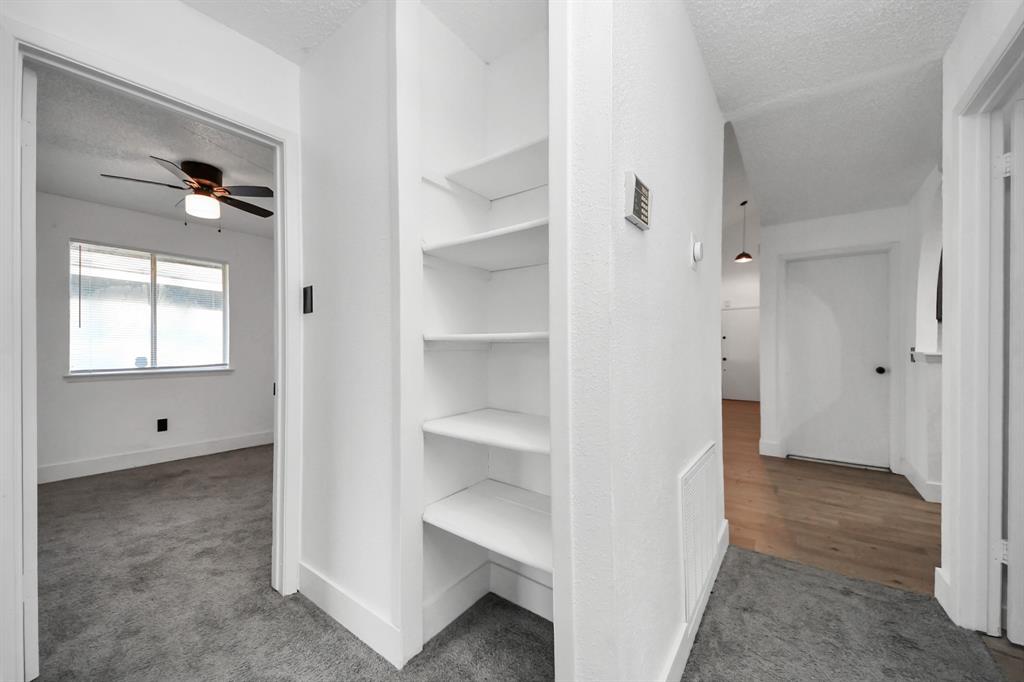 Storage space in hallway leading to bedrooms.