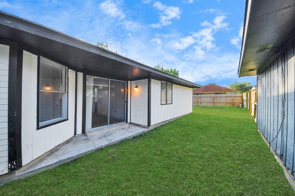Back patio leading to an oversized backyard.
