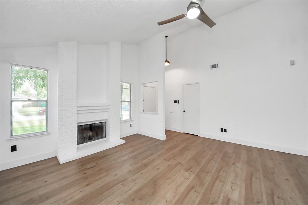 Spacious living room with cozy fireplace.