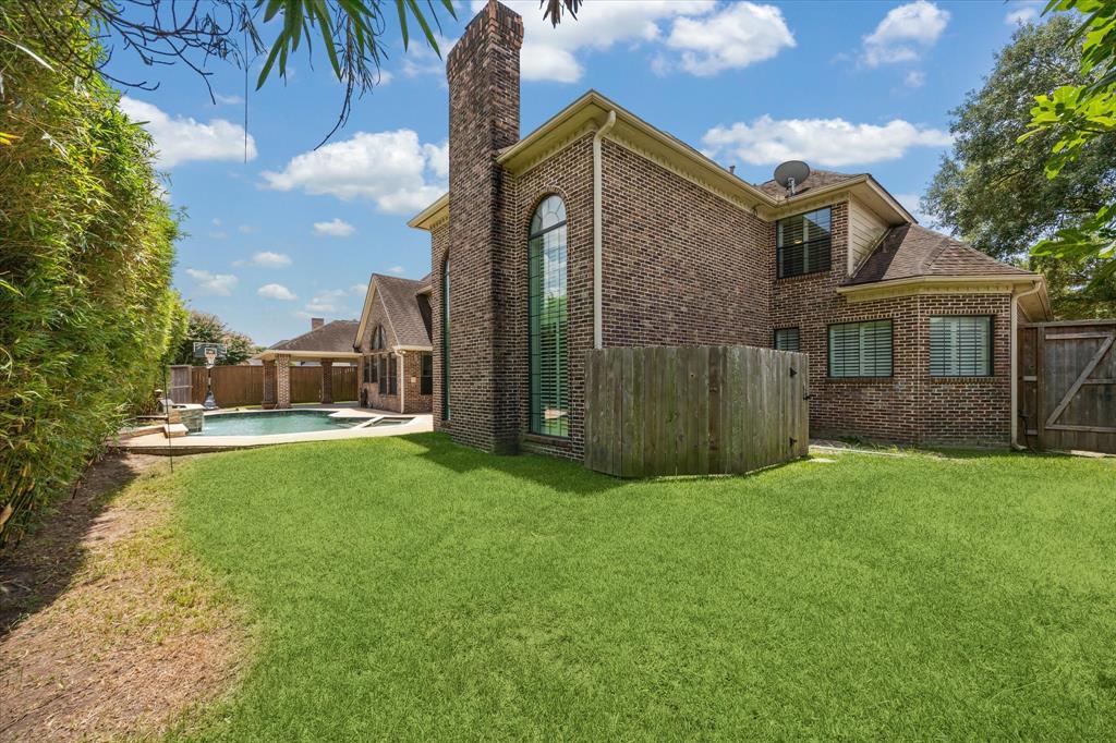 The spacious backyard offers the best of both worlds—lush green space for play or pets, and a beautifully updated saltwater pool with a resurfaced pebble finish, water feature, pool heater, and sprayed decking. A perfect setting for relaxing, entertaining, or enjoying sunny Texas days.
