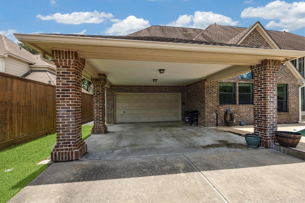 Generous gated back parking complemented by multiple covered spaces and a stately porte cochere for seamless entry.